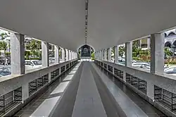 Walkway to the mosque; shoe racks on each side