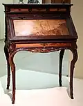 Desk (Art Nouveau), presented at the 1900 Paris Exposition; by Émile Gallé; 1900; molded and carved oak, with chiseled and patinated bronze; height: 108.5&nbsp;cm; Musée d'Orsay (Paris)[68]
