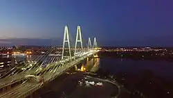 Meeting of the auto club under the Cable-stayed bridge in the evening
