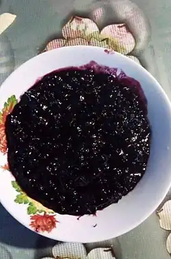 A bowl filled with a black dessert