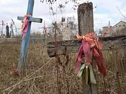 Wooden grave crosses decorated with ribbons