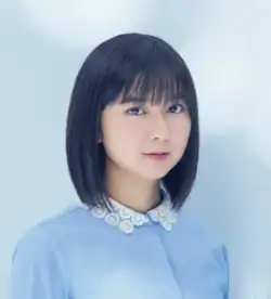 Moka Kamishiraishi in a light blue dress against a light blue backdrop.