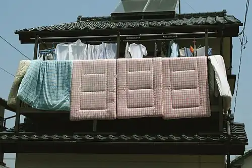 Futons hung out to air on a balcony
