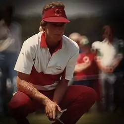 Bernard Langer crouched down to analyze a shot.