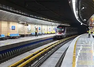Top: Outside view of Imam Khomeini station Bottom: A train at the Ghoddoosi Metro Station