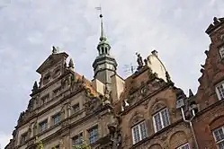 A sculpture on the façade of the English House (left) in Gdańsk was reconstructed by the artist at the beginning of the 1980s