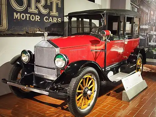 A red 1922 Dort sedan car showing design features derived from a Rolls-Royce model