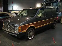 A 1986 Dodge Caravan with simulated woodgrain meant to evoke the wooden body pieces of some older cars