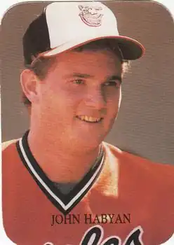 A man in an orange baseball jersey and white cap
