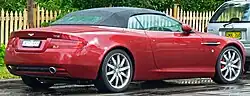 Rear three-quarters view of a red DB9 Volante convertible