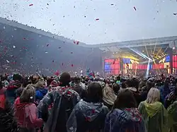 A One Direction concert in Sunderland, showing red confetti raining down onto fans.