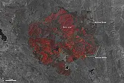 With the same point of view as above the Rocky Fire stands out vibrantly as shades of red and orange against now-gray land cover