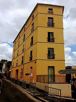 angled apartment block at intersection of two streets