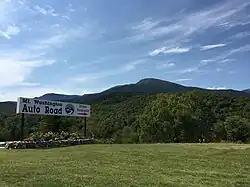 Sign at the bottom of the road, with Mount Washington visible ahead