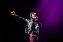 Raury supporting Macklemore & Ryan Lewis at a concert in 2016