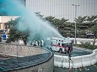 Police using blue-dye water cannon to disperse protesters