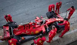 From above, Leclerc parked in the pit lane, with mechanics putting tyre blankets on his Ferrari SF1000 at 2020 Formula One pre-season testing
