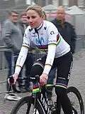 Female cyclist in white jersey riding a bike