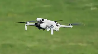 a DJI Mini 4 Pro in the air