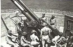 Gunners working on 3.7-inch (94&nbsp;mm) heavy anti-aircraft gun. 1943.[gallery 21]