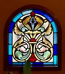 Romanian Revival acanthuses on a stained-glass window of the Kiseleff Roadside Buffet&nbsp;[ro] (Șoseaua Kiseleff no. 4), Bucharest, Romania, by Ion Mincu, 1889-1892[19]