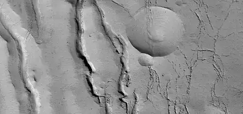 Close view of cracks of various sizes, as seen by HiRISE under HiWish program. Ice disappears along crack surfaces and makes crack larger.