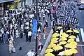 About 250 people dressed in black participated in the parade in Tokyo. Protesters held up yellow umbrellas and raised the black flag of Liberate Hong Kong, Revolution of Our Times