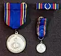 Military Academy Karlberg Medal of Merit in silver with ribbon and miniature medal (obverse)
