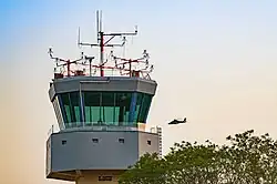 ATC Tower at Ramat David Airbase in August 2023 with an AS565 Panther Atalef flying by