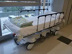 Hospital bed with rails raised on the side