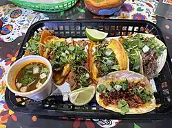 A variety of tacos, including quesabirria, suadero, chorizo and carnitas.