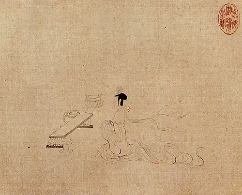 Woman seated in front of an empty table