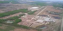 Aerial view of industrial building and airport on north end of community