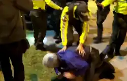 Police tackle Roberto Canseco, the acting head of the Mexican mission, to the ground.[22]