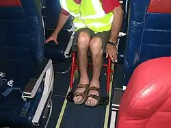 An aircraft aisle chair inside a Virgin Australia cabin