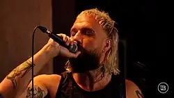 Akira singing during a set on the Normal World Show