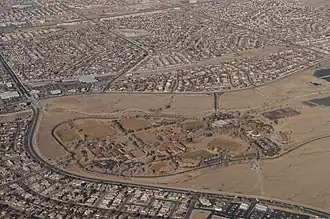 Aerial color photograph including sports fields surrounding a complex of school buildings