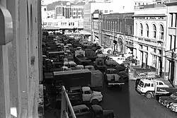 Photo of many goods vehicles in crowded street.