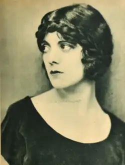 Black and white photograph of Rubens looking off to the side, wearing a dark velvet dress