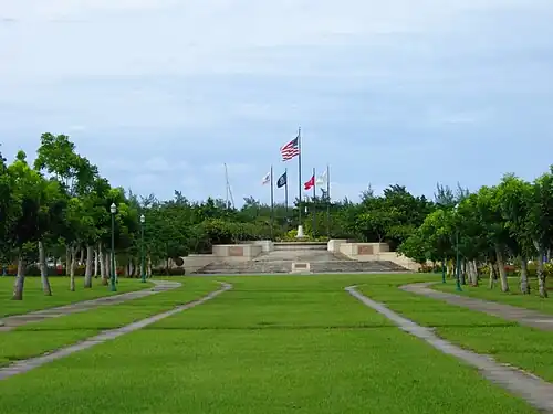 Perspective photograph of Park, which rises on wide stairs ending with a court and a flag circle of five flags