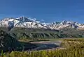 Amulet Peak (left) rising above Matanuska River, with parent Awesome Peak to right of center