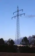 Suspension tower of a 110 kV-line with anchorage of garland-like communication cable on the ground conductor and its conduction downward in the body of the tower