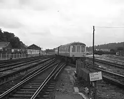 A black-and-white photograph of a diesel train crossing a set of points