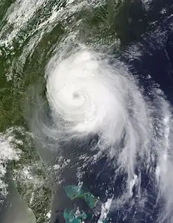 A visible satellite image of a well-formed hurricane, with multiple spiral bands and an eye, nearing landfall in North Carolina on July 3, 2014.