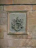 The Dunlop family Coat of Arms on the wall of the house.