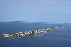 Aerial photo of Kivalina, Alaska showing its proximity to sea level and potential for flooding and being submerged