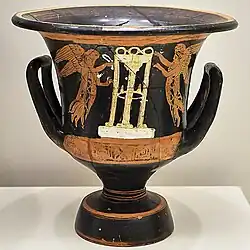 Two flying Nikes each holding a tainia in both hands on either side of a victory tripod, calyx krater, Athens, National Archaeological Museum 13900 (fourth century BC).[128]