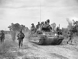 Australian troops from the 2/43rd Battalion advance with a Matilda tank on Maeda-shima in a sweep mission to clear the area of Japanese troops, 12&nbsp;June 1945