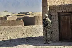 Australian Army Pvt. Brent Rothwell patrols in Tarin Kowt with an HK417, Uruzgan province, Afghanistan, July 26, 2013.