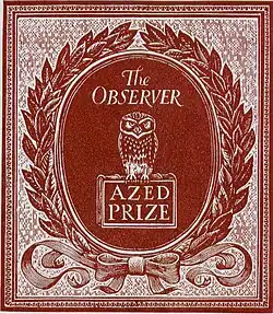 A laurel wreath around an oval plaque. The plaque shows an owl sitting on a book and the words 'The Observer AZED PRIZE'. The wreath is tied at the base with a ribbon bow with the two ends spread out sideways.